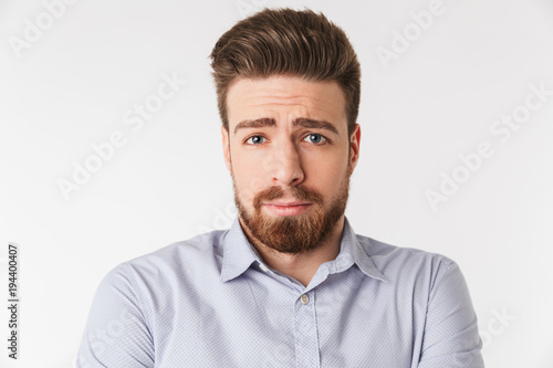 Close up portrait of a sad young man dressed in shirt