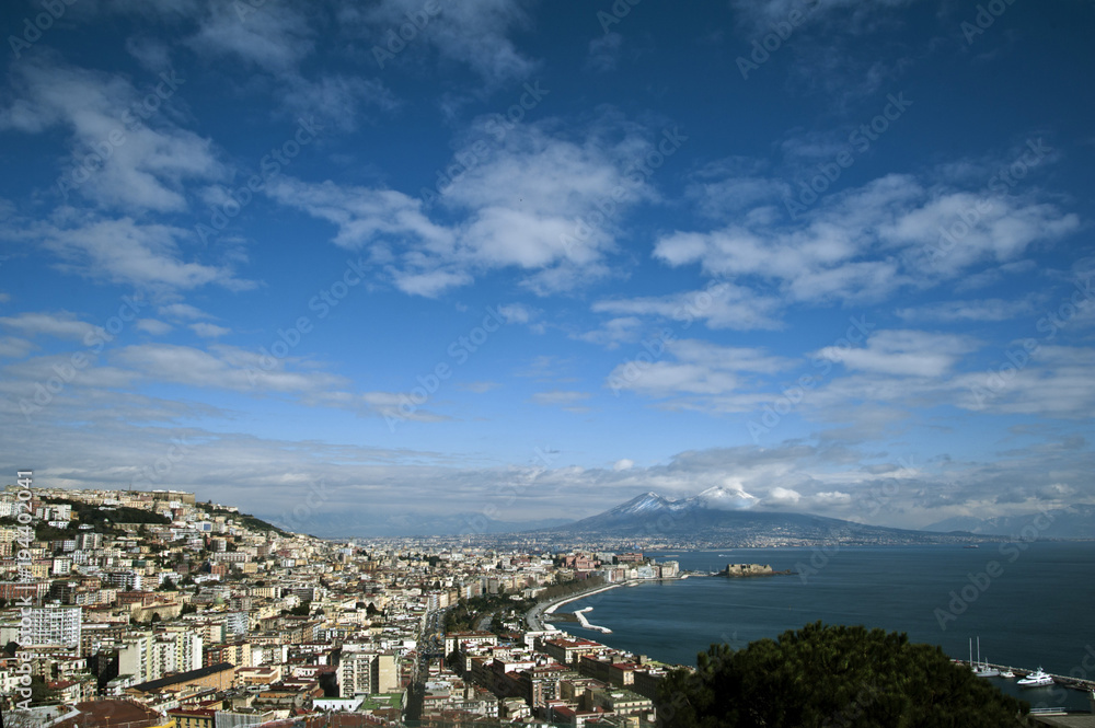 2018 february. Naples with the snow-covered Vesuvius. The Caracciolo seafront and the Castel dell'Ovo, the oldest of the city's castles.