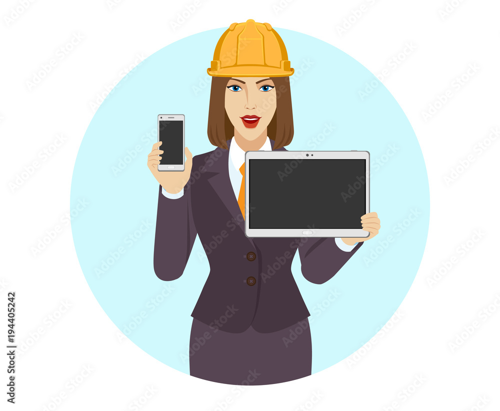 Businesswoman in construction helmet holding a mobile phone and digital tablet PC