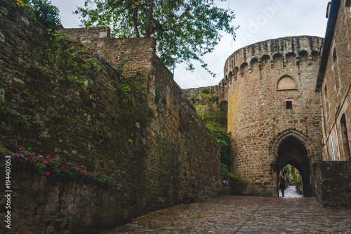 Fortification walls and stone guard tower with gateway in medieval Dinan, Brittany, France photo