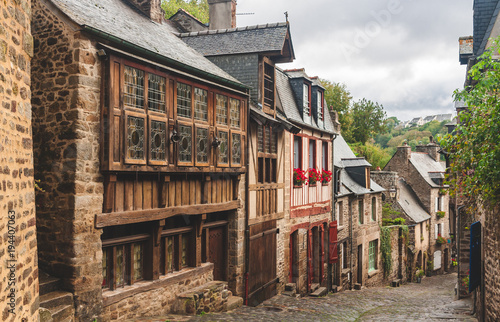 Pedestrian medieval cobbled street with traditional half-timbered houses on sides in old town of Dinan  Brittany  France