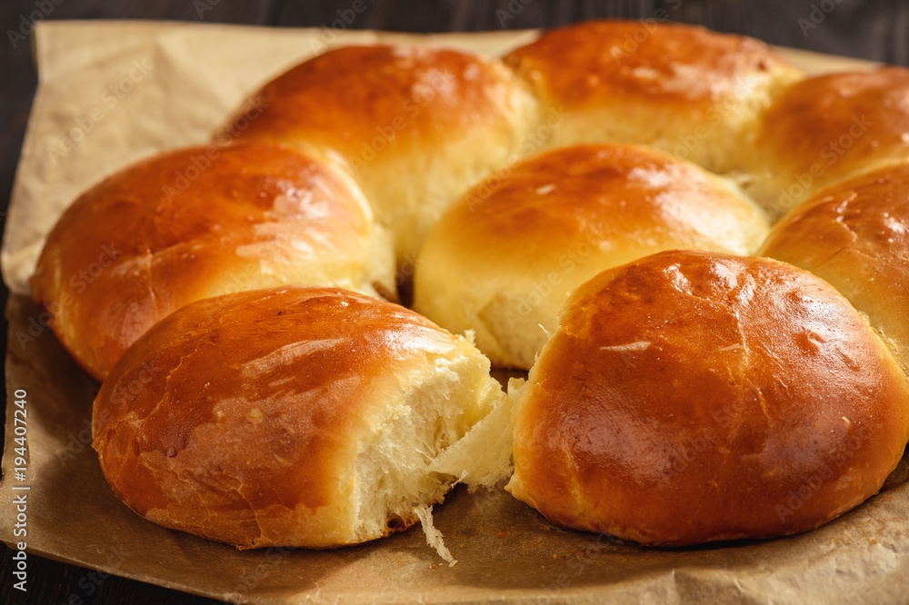 Homemade sweet bread rolls on dark background.