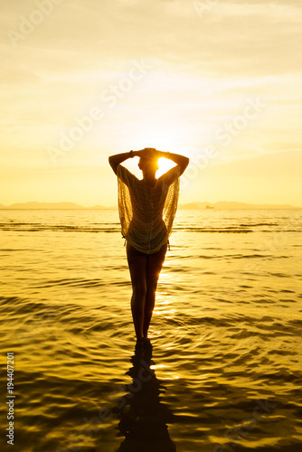 Silhouette of a Beautiful Woman at the beach in Thailand at sunset