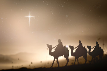 Silhouette of three wise men on camels following the cross shaped star to Bethlehem, concept of nativity and Jesus Christ birth