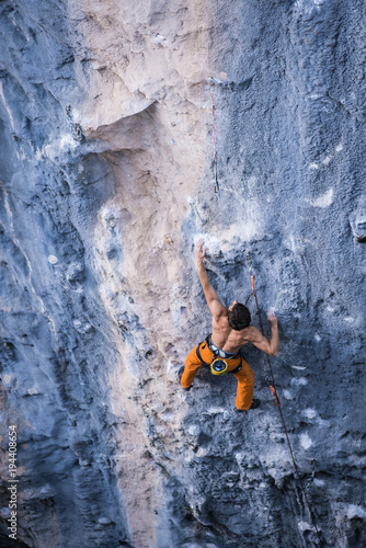Fototapeta Naklejka Na Ścianę i Meble -  Men climbs a rock with a rope, lead, Chitdibi, Turkey