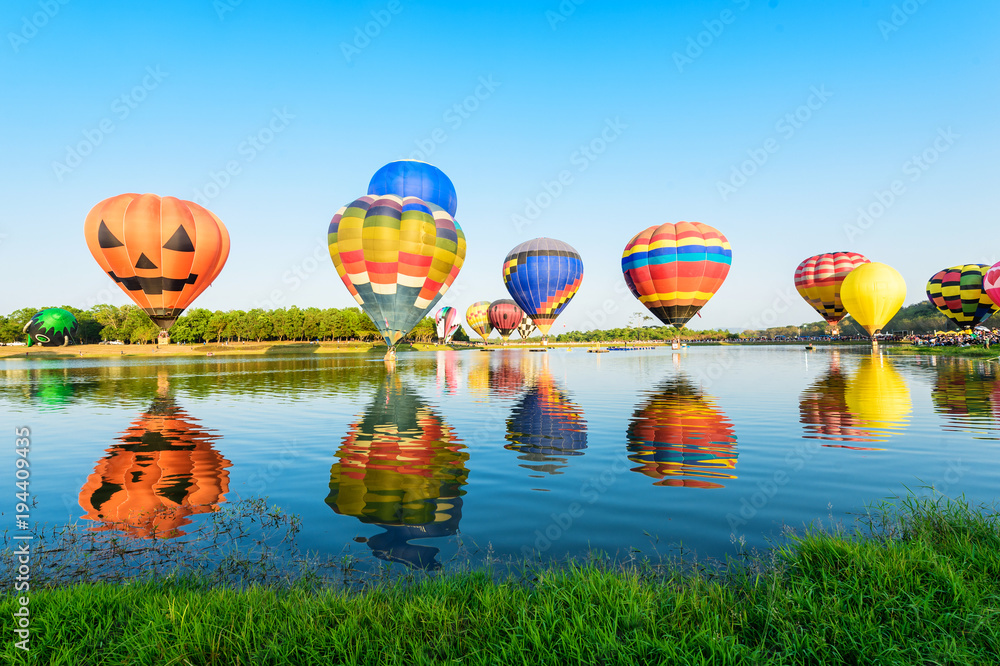 Fototapeta premium Group of colourful balloons on the lake