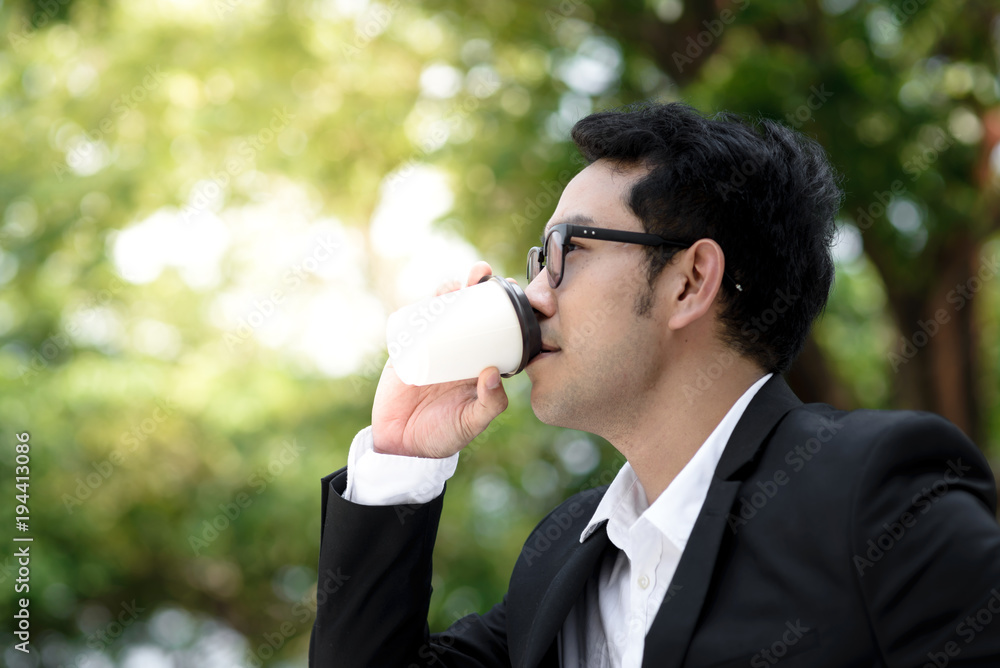 Happy businessman drinking coffee cup with nature background. Lifestyle concept. Happy businessman drinking coffee cup with nature background. Lifestyle concept.