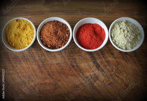 Various colorful spices on wooden table. Top view