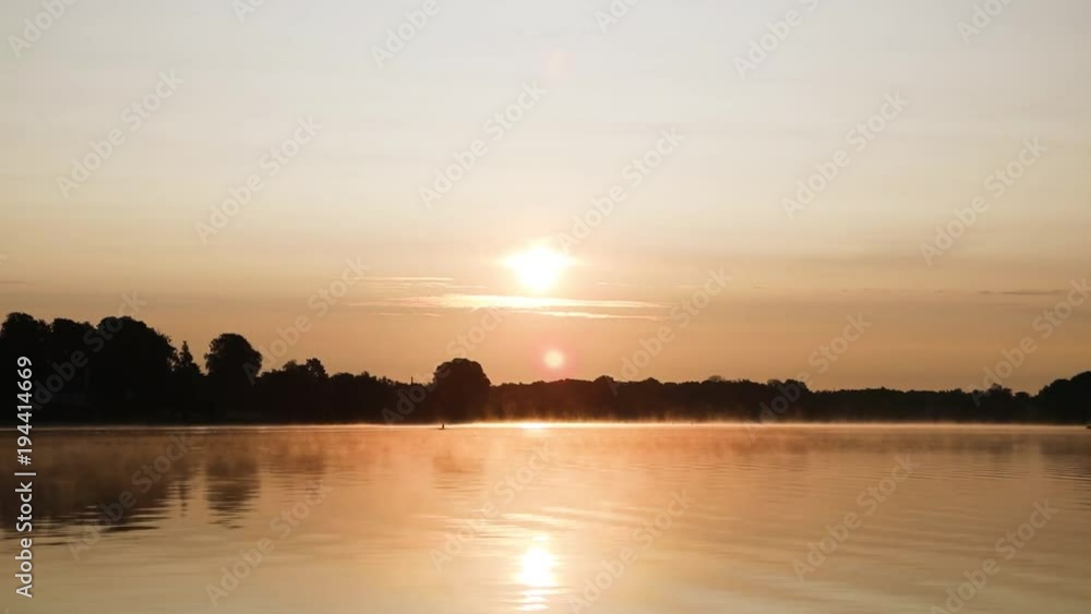 Rowing at lake in the sunrise Rowing at lake in the sunrise