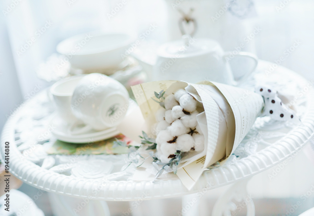 table with flowers and tea cups table with flowers and tea cups