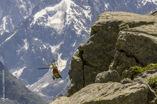 Rescue helicopter on the background of mountains. Mont Blanc massif. Alps.