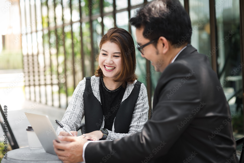 Business woman sitting at cafe outdoor and discussing with her team. Business woman sitting at cafe outdoor and discussing with her team.