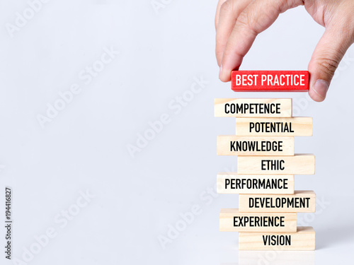 Businessman Building BEST PRACTICE Concept with Wooden Blocks photo