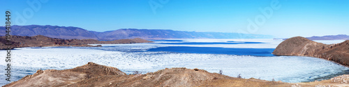 Baikal Lake in spring day. Top view of the Kurkut Bay at the beginning of the ice drift. White ice on blue water. Panorama