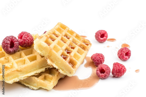 Traditional waffle (Belgian) with fresh red raspberries and syrup isolated on white background three sweet delicate and airy.