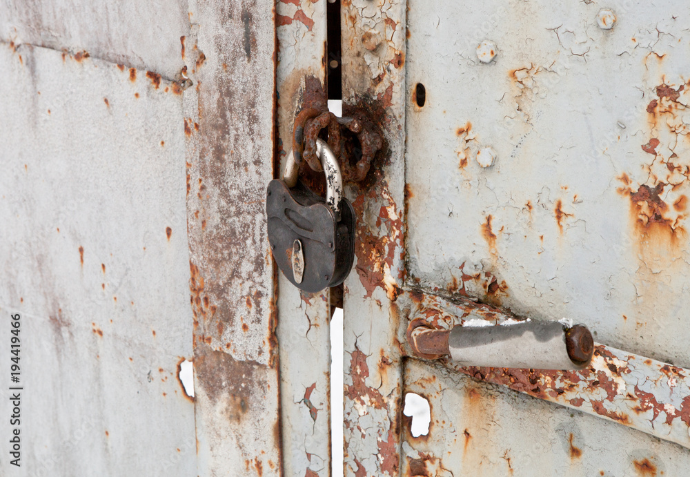 Old padlock on the metal door