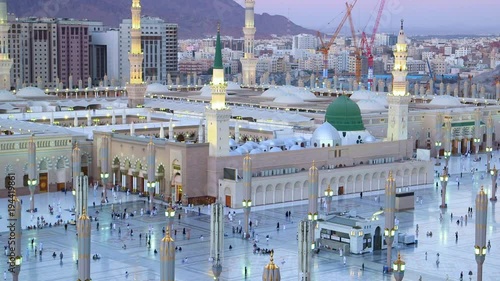 Muslims entering the Prophet’s mosque in Medina with the Green Dome in view photo