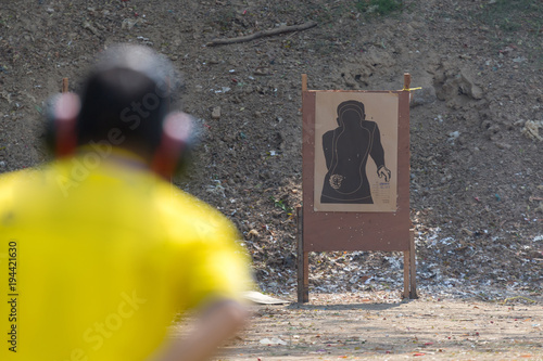 shoter shooting  gun on an outdoor shooting range, selective focus photo