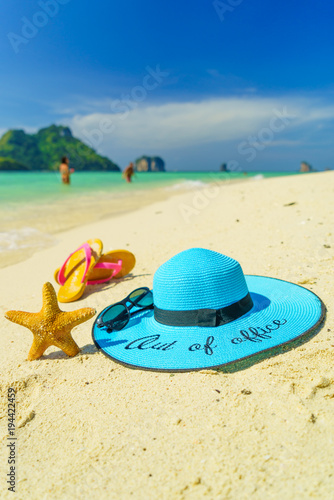 Out of the office Straw hat starfish and sandals onPoda island beach white sand and turquoise sea