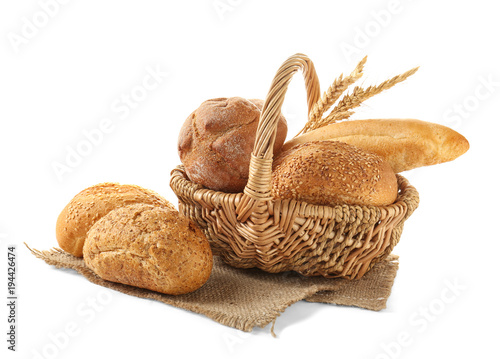 Basket with bread products on white background