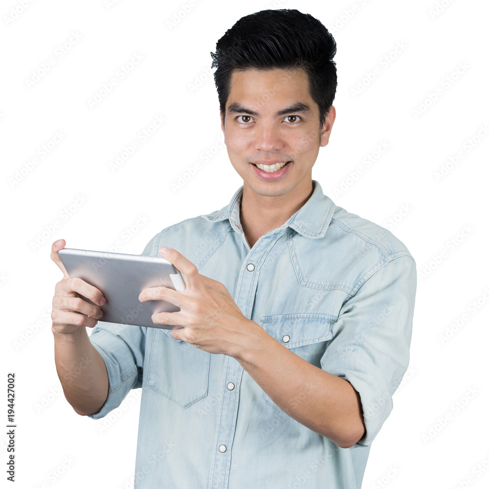 Portrait handsome young asian man wearing a blue jean shirt holding smart phone or tablet happy business isolated on white background. Asian man people. business concept. Portrait handsome young asian man wearing a blue jean shirt holding smart phone or tablet happy business isolated on white background. Asian man people. business concept.