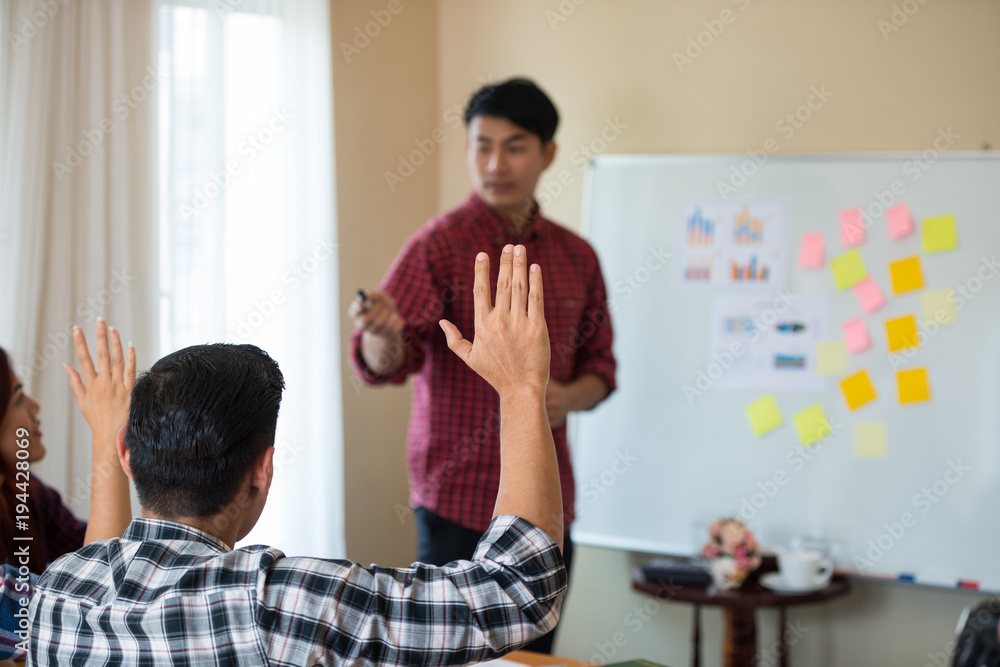 Hand of young Asian men wearing casual plaid shirt is asking for feedback from he colleagues at the Conference about running a successful business. teamwork business meeting Hand of young Asian men wearing casual plaid shirt is asking for feedback from he colleagues at the Conference about running a successful business. teamwork business meeting