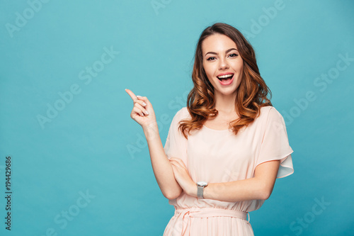 Happy young lady pointing.
