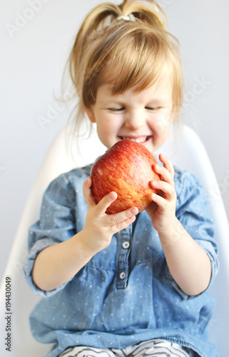 Portrait of Little Girl Eating Breakfast at Home Fruits Apple Summer Concept of Healthy Food for Children