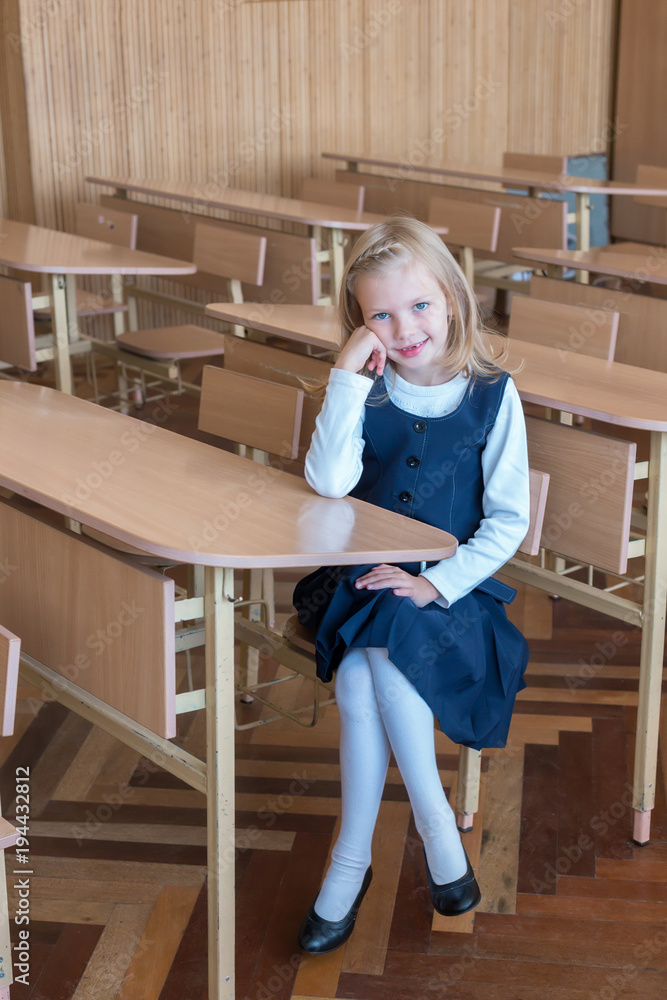 girl in the first grade, is sitting at the desk girl in the first grade, is sitting at the desk