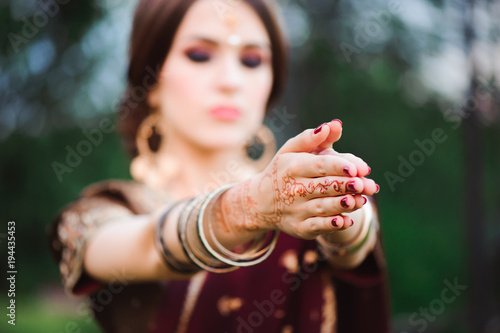 Mehndi tattoo. Woman Hands with black henna tattoos. India national traditions