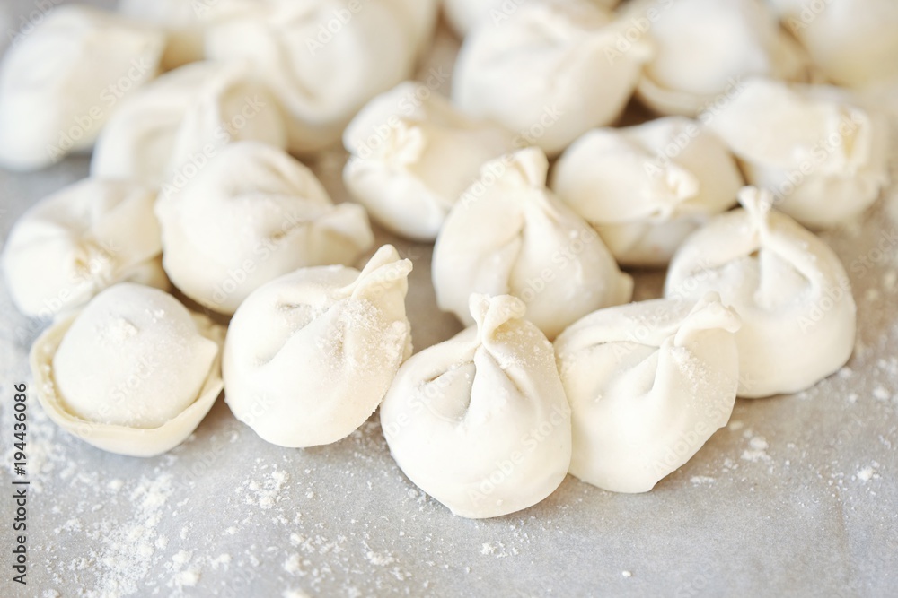 Homemade dumplings and flour on the table Homemade dumplings and flour on the table