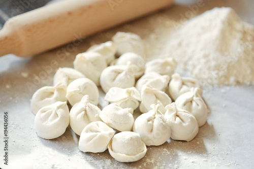 Homemade dumplings and flour on the table 