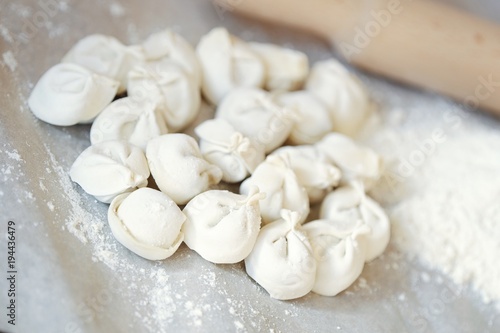 Homemade dumplings and flour on the table