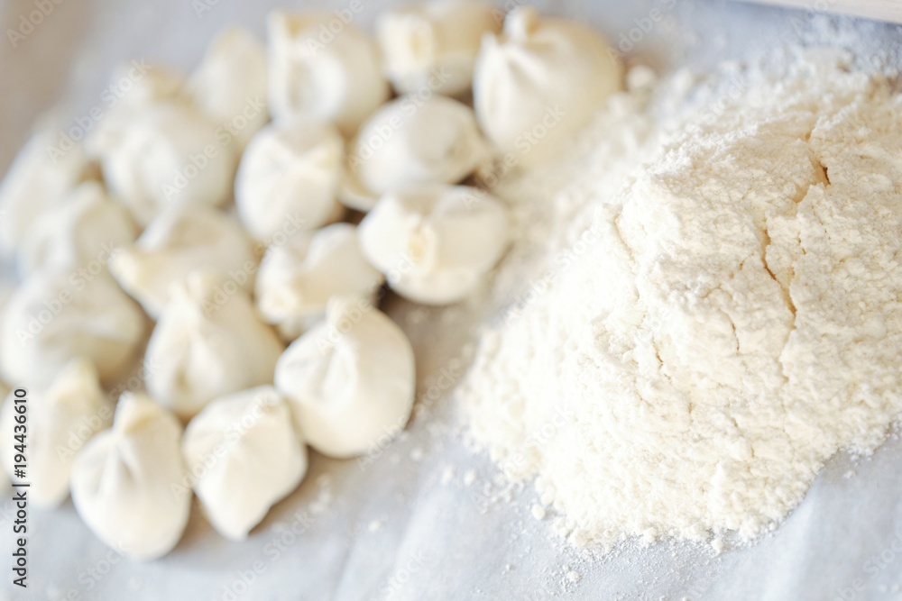 Homemade dumplings and flour on the table Homemade dumplings and flour on the table