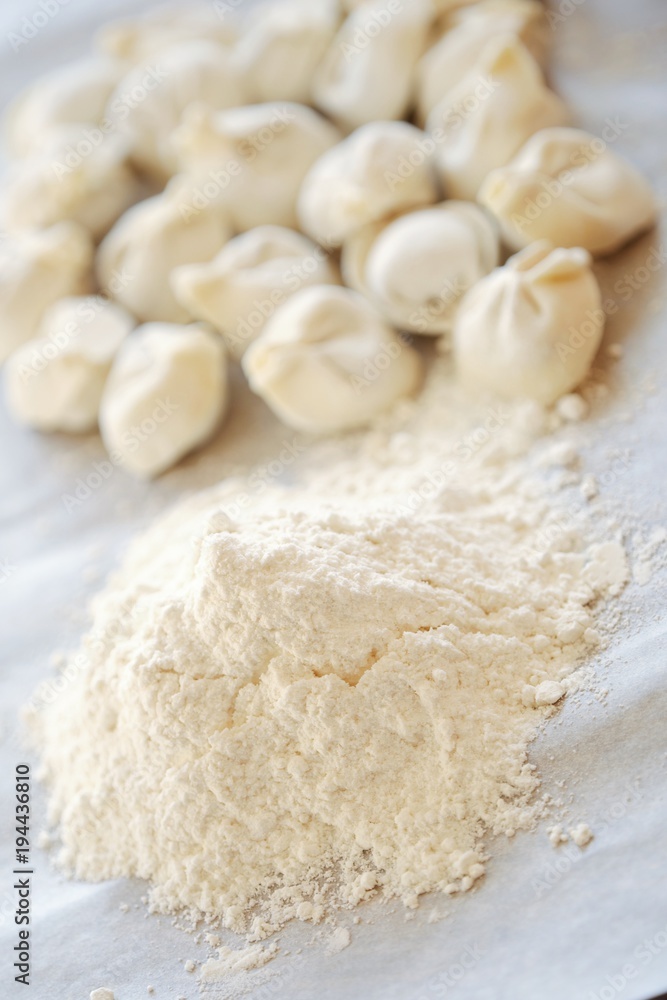 Homemade dumplings and flour on the table