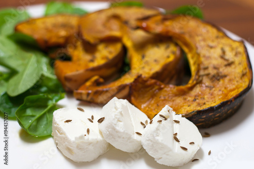 dish pumpkin with spinach, goat cheese and cumin seeds