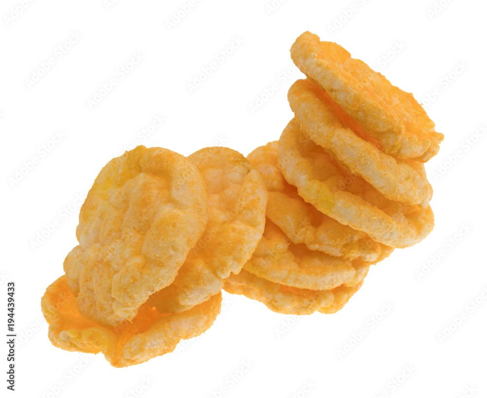 Cheddar cheese rice cakes in a messy stack isolated on a white background. Cheddar cheese rice cakes in a messy stack isolated on a white background.
