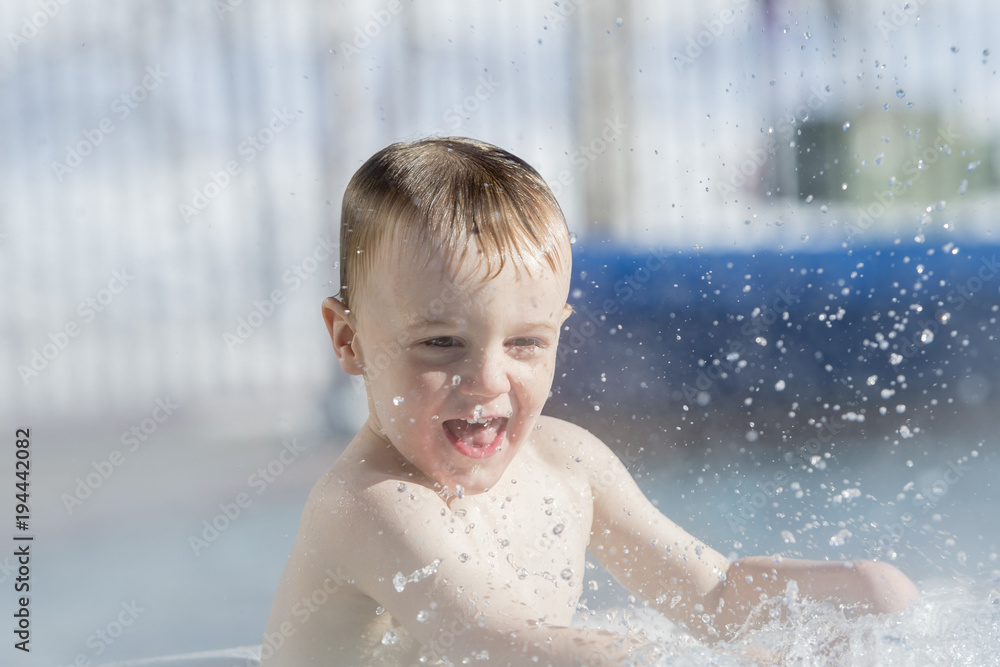 Toddler Boy Playing in a Warm Water Pool During the Winter at Ski Resort Toddler Boy Playing in a Warm Water Pool During the Winter at Ski Resort