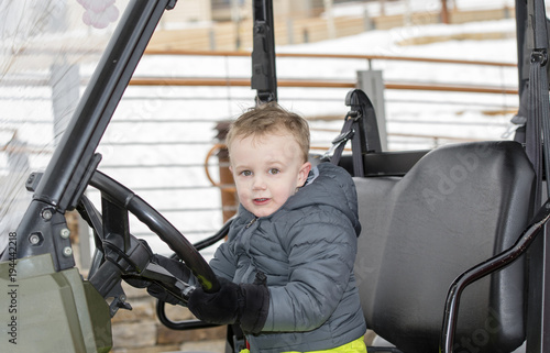 Toddler Boy Playing in a Snow Jeep During the Winter at a Colorado Ski Rsort