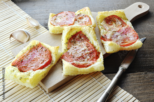 Homemade puff pastry pizzas with origan and tomatoes