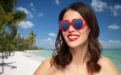 woman with red lipstick and heart shaped shades © Syda Productions