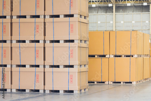 cardboard boxes are stacked on wooden palette in cargo, finish products are ready to delivery from transportation logistics in storage warehouse