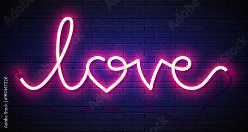 Word Love neon sign on bric...