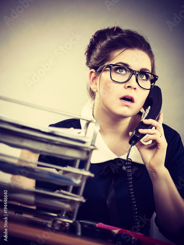 Business woman in office talking on phone