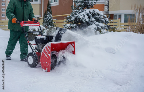 Man Removing Snow with a Snow Blower Winter