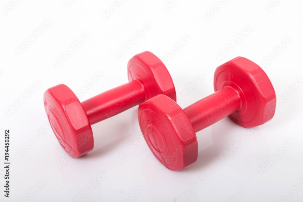 Red dumbells. Isolated on a White Background. Red dumbells. Isolated on a White Background.
