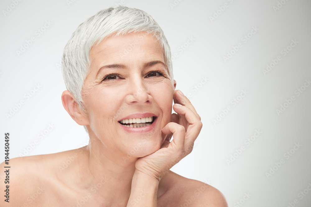 Portrait of beautiful senior woman in front of white background. Portrait of beautiful senior woman in front of white background.