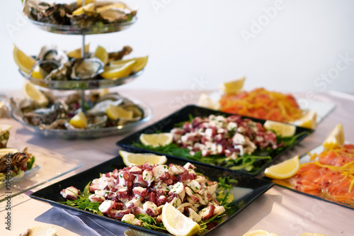 Octopus salad  on background oysters and salmon