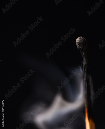 A wooden match and smoke from it