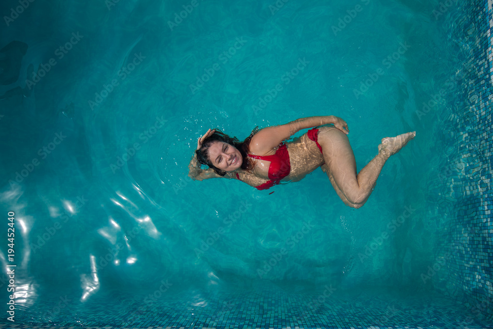 Girl Portrait Posing Underwater With Red Bikini In Swimming Pool